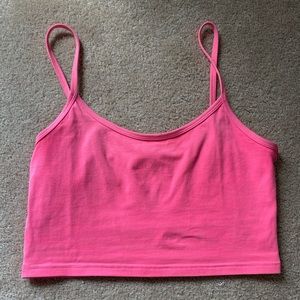 A neon pink tna cropped tang top